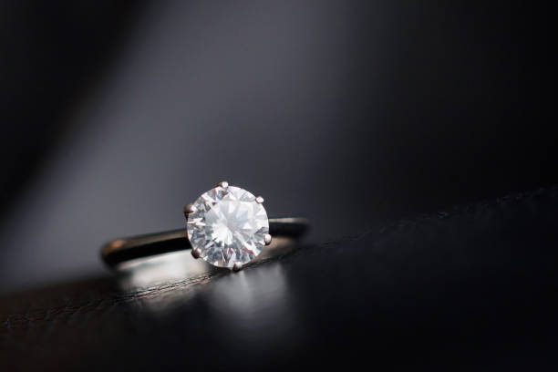 istock Close up diamond ring jewelry on black leather background 1174987086