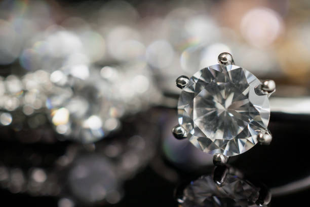 istock Jewelry wedding diamond rings on black background with reflection 1174987089