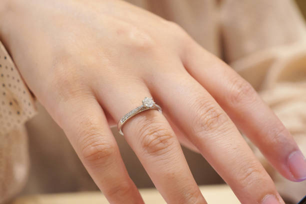 istock Close up diamond ring on woman finger 1174987093
