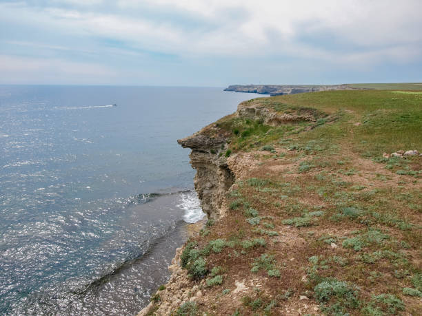 istock Sea coast with steep textured limestone rocks and distant horizon 1174988177