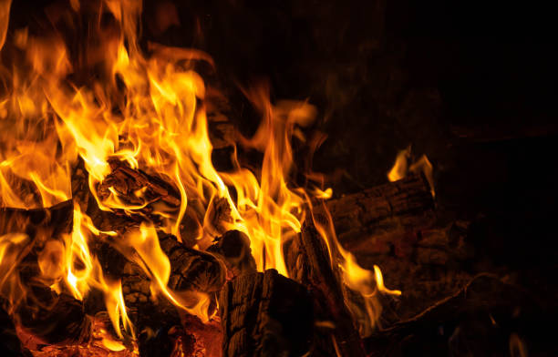 istock fireplace background burning wood on black 1174988292