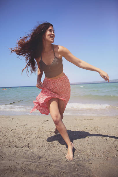istock Woman having fun at beach 1174988512