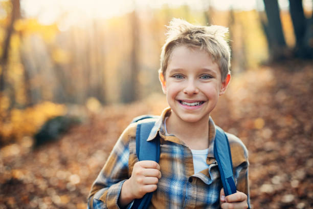 istock Little boy enjoying autumn forest 1174989445
