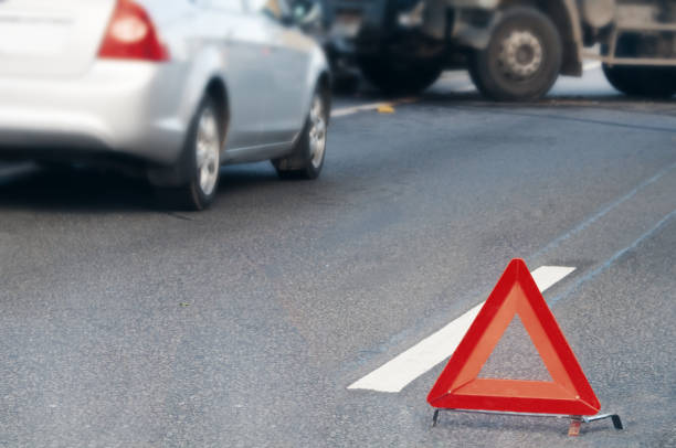 Emergency stop sign placed in front of colliding vehicles
