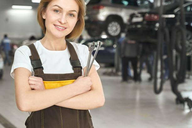 istock Professional female mechanic keeping wrench and posing 1174990831