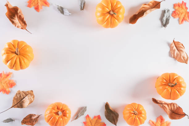 istock Autumn composition. Orange pumpkin with autumn leaves on white background. Flat lay, top view copy space. 1174991542