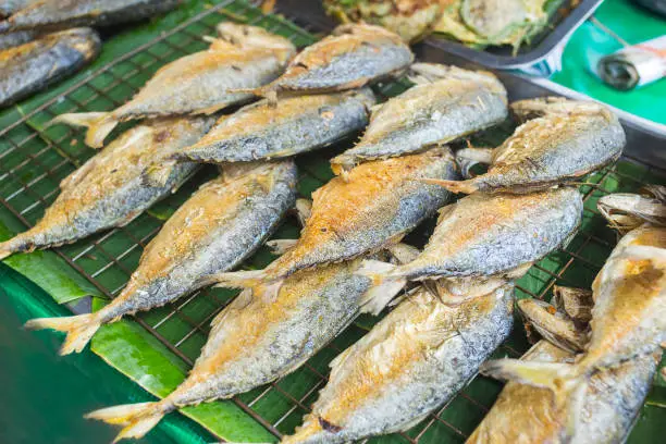 Photo of Fried mackerel on the  grille for sale in the market.