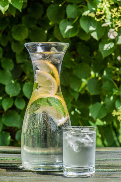 istock Glass of water and carafe on table 1174994130