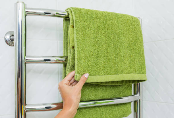 istock Green towel on heated rail in bathroom. 1174994740