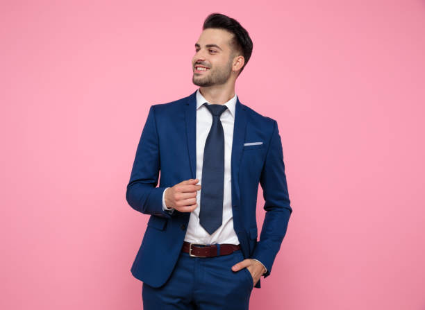 istock attractive young man looking to side on pink background 1174994885