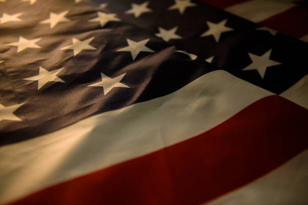 istock US American flag and warm sun light 1174996526