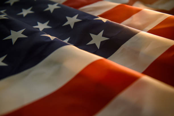 istock US American flag and warm sun light 1174996654