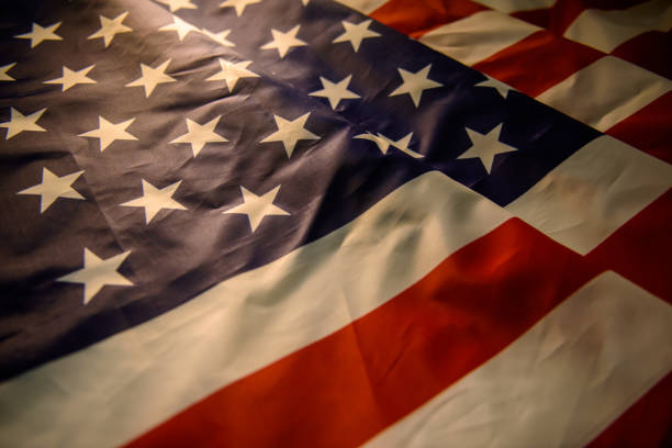 istock US American flag and warm sun light 1174996684