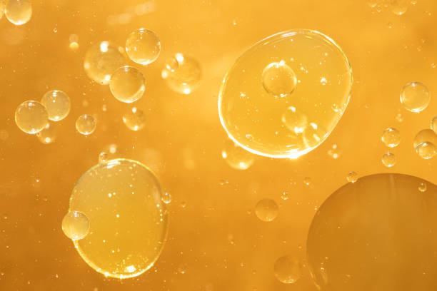 istock golden yellow bubble oil droplet, abstract background 1174996802