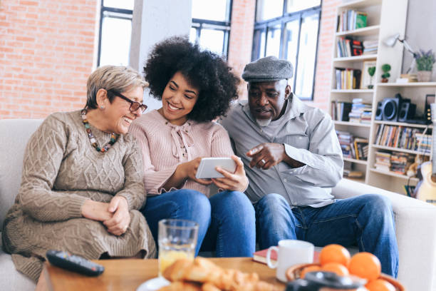 istock Multi-ethnic family having fun at home using smart phone 1174996871