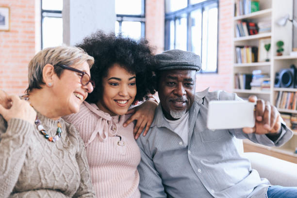 istock Multi-ethnic family having fun at home using smart phone 1174996880