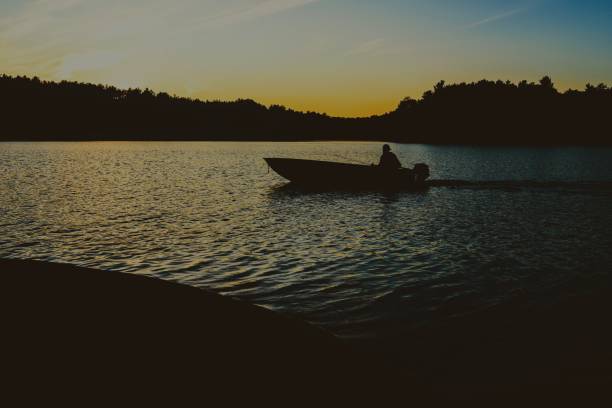 istock Sunset lake fishing 1174999212