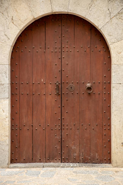 istock Arched wooden brown door 1174999665