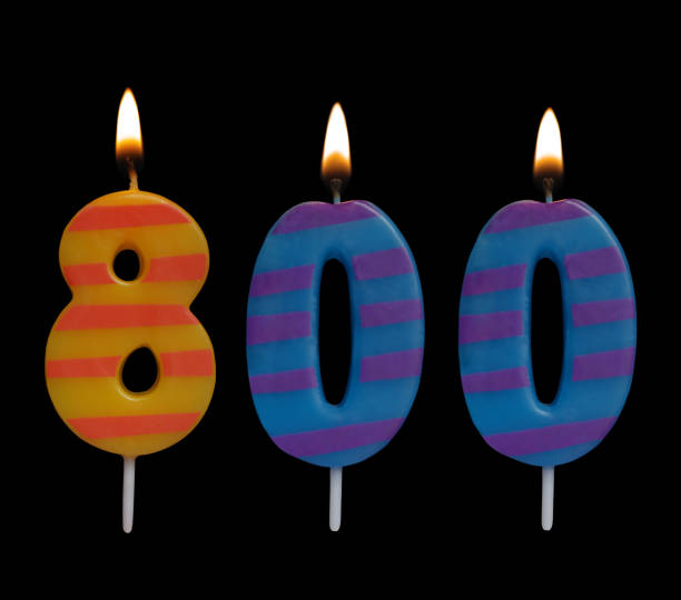 istock Burning birthday candle isolated on black, number 800 1175002723
