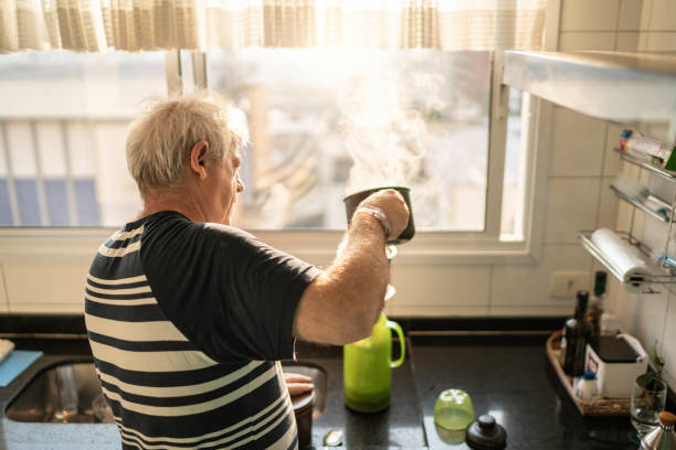 istock Senior man preparing coffee in the kitchen 1175003229