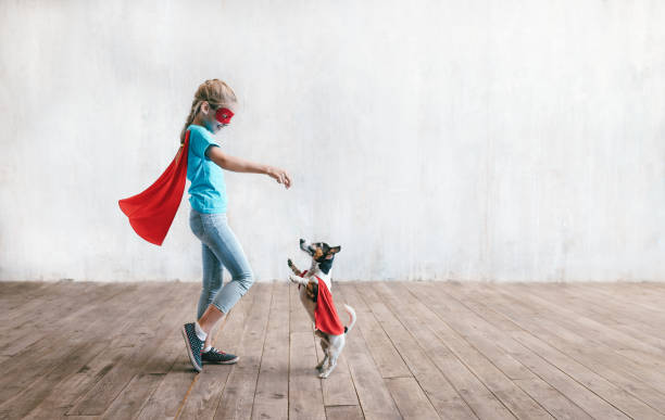 istock Little super girl with a dog 1175003351