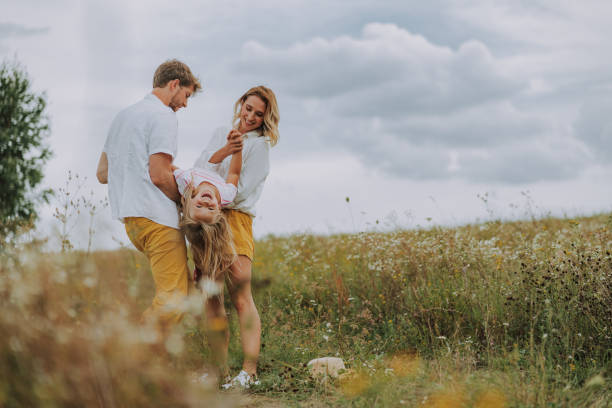 istock Happy parents holding their daughter on hands 1175003845