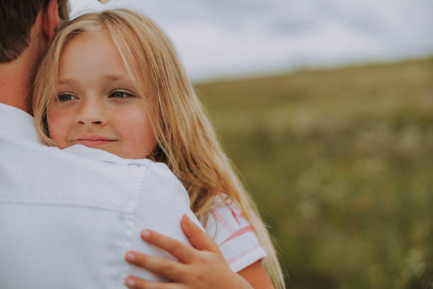 istock Pretty little daughter is hugging her father 1175003944