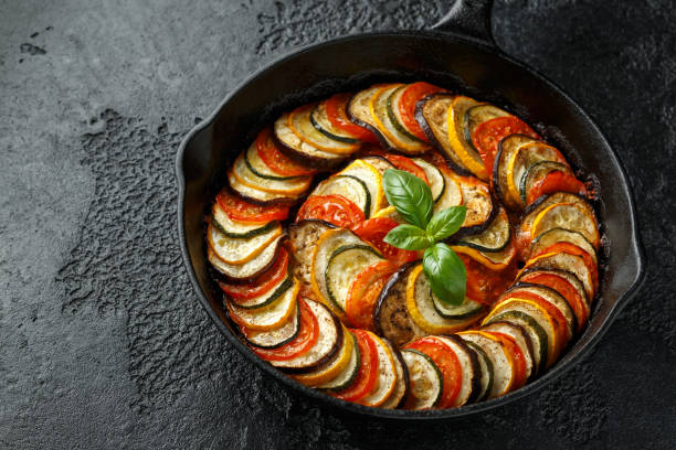 istock Ratatouille Vegetable Stew with zucchini, eggplants, tomatoes, garlic, onion and basil. on cast iron pan. Traditional French food. 1175004200