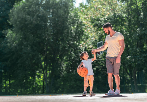 istock Father and son with a ball 1175005036