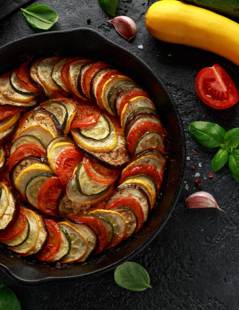 istock Ratatouille Vegetable Stew with zucchini, eggplants, tomatoes, garlic, onion and basil. on cast iron pan. Traditional French food. 1175005169