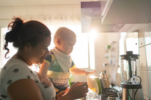 istock Babysitter and baby boy at kitchen 1175005684