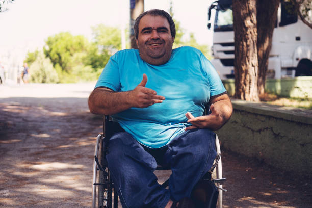 istock disabled man in wheelchair walking park 1175005767