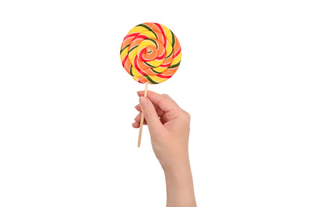 istock Lollipop in female hand isolated on white  background. Space for text or design. 1175007490