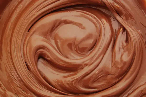 Chocolate spread as background, melted chocolate close up