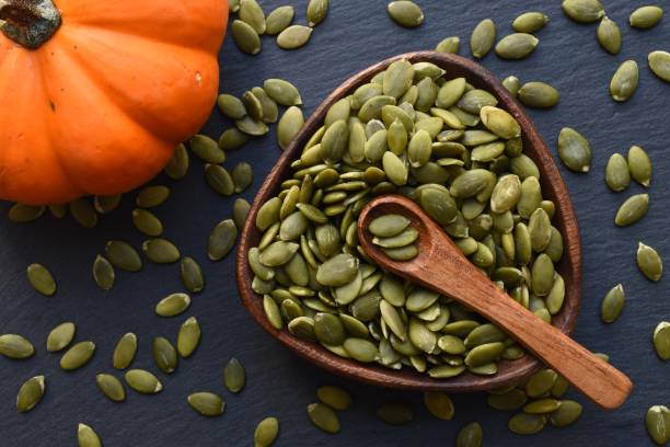 pumpkin seeds - vegan food still life horizontal image imagens e fotografias de stock