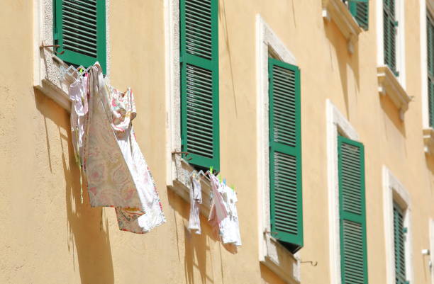 istock Clothes washing line and green window background Rome Italy 1175009852
