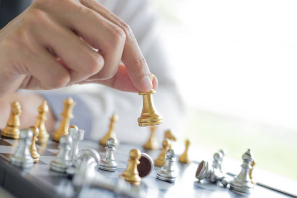 istock A young business man is playing chess, business strategy to be successful 1175012112