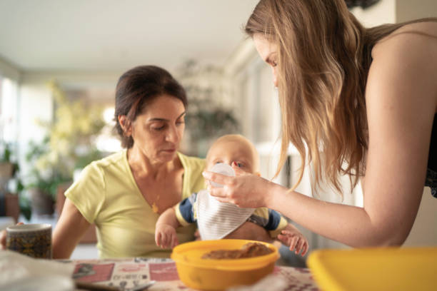 Grandmother, mother and grandson having breakfast together Grandmother and grandson having breakfast together mother in law stock pictures, royalty-free photos & images