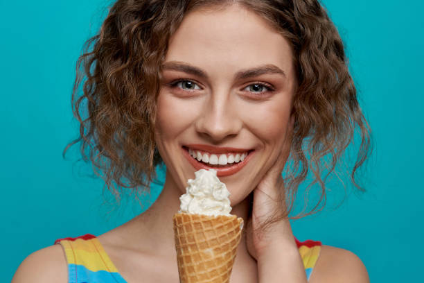 istock Cheerful girl holding wafer cone with white ice cream. 1175014422