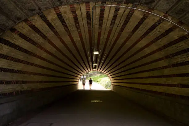 Photo of Unrecognized people walking under the bridge