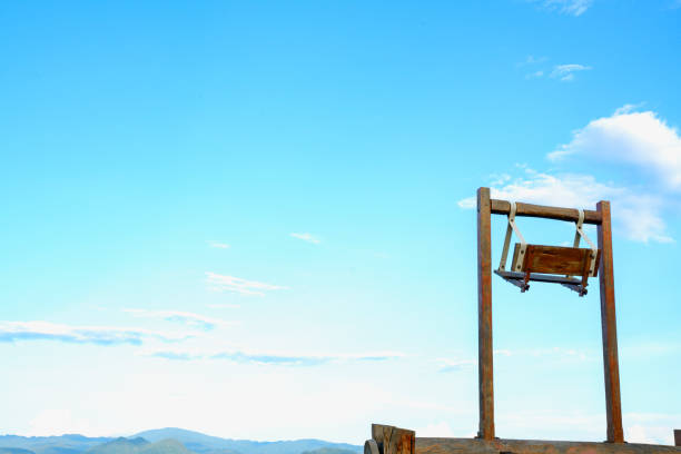 Wooden swing chair up on sky in a beautiful sunshine day