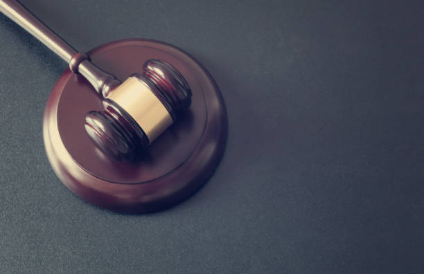 istock Wooden judge gavel on dark table 1175016210