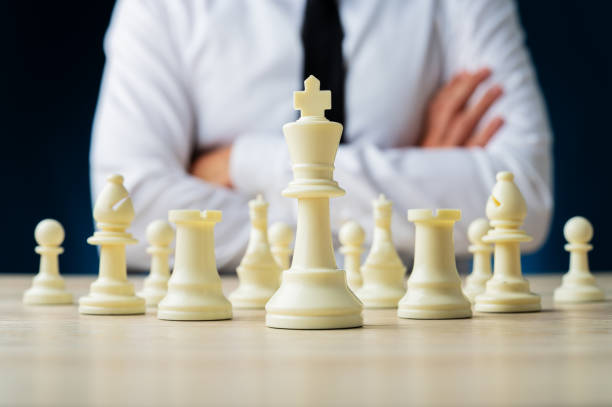 istock Business executive sitting at a desk with chess pieces 1175016766