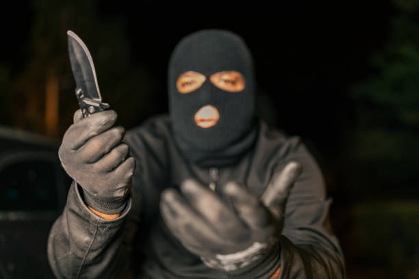 istock Bandit with knife on dark background 1175017626