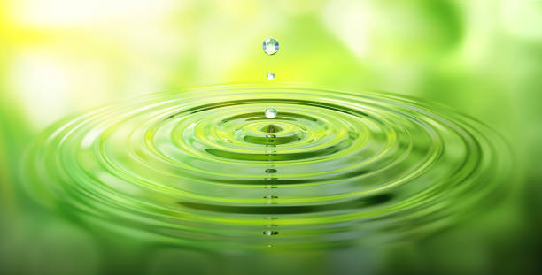 istock Water drop with ripples and green reflection stock photo 1175017888