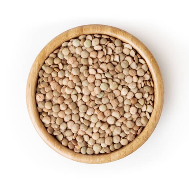 uncooked lentils in wooden bowl isolated on white background with clipping path - green lentil imagens e fotografias de stock