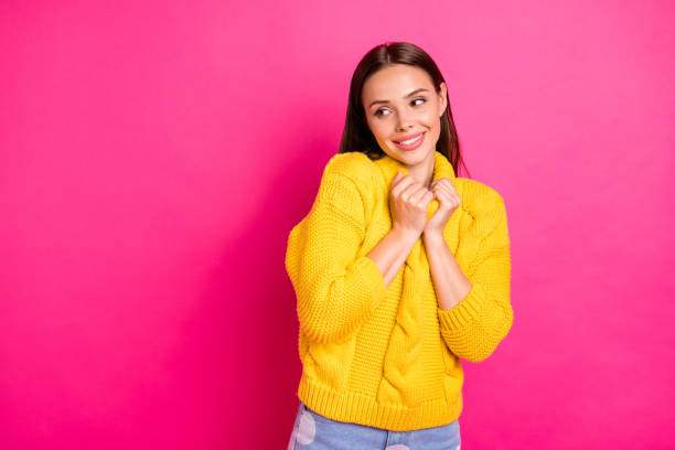 istock Portrait of charming woman touching her pullover looking isolated over pink background 1175020995