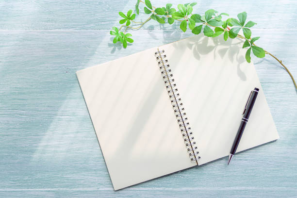 istock Notebook and pen on wooden background 1175021114