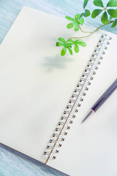 istock Notebook and pen on wooden background 1175021181