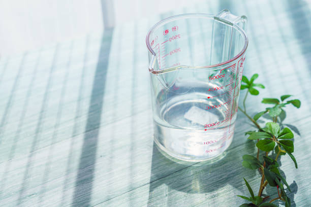 Measuring cup isolated on wooden background